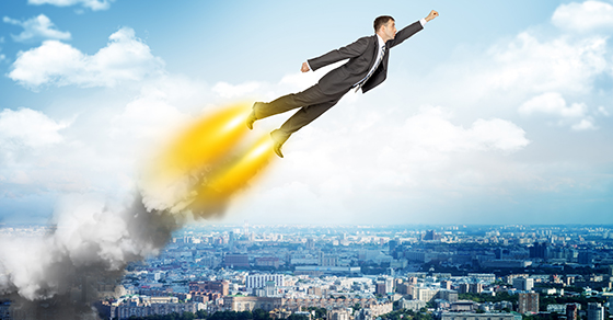 Businessman in suit flying above cityscape, front view