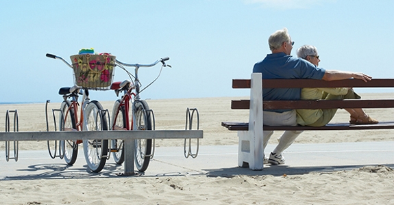 Older couple on a bench at a beach