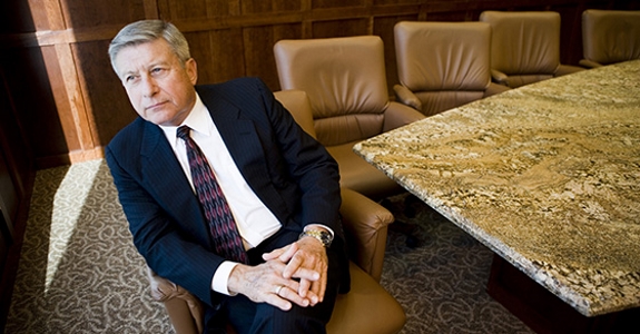 Contemplative businessman sitting on armchair in an office