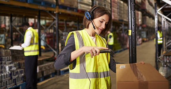 Woman using a barcode reader in a distribution warehouse