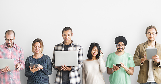 Diverse group of people holding different mobile devices