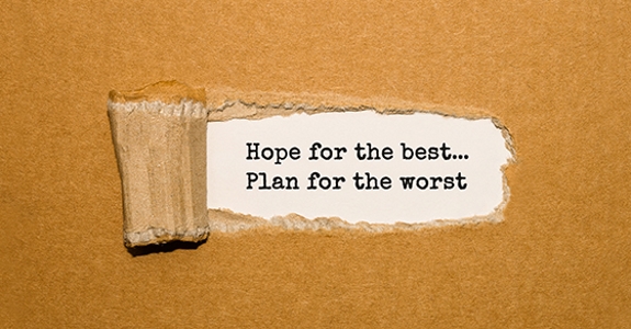 The text Hope for the best Plan for the worst appearing behind torn brown paper
