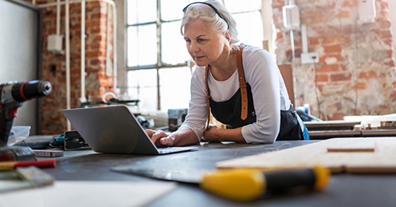 Confident senior woman working in workshop