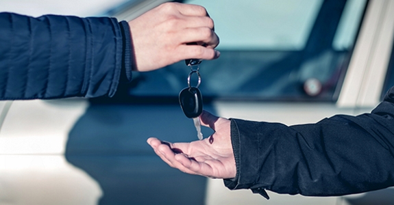 Person handing car key to another person