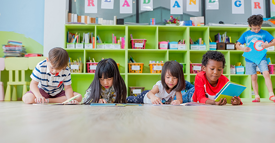 Children sitting and lying on floor in classroom