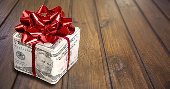 U.S. paper money in shape of a box and wrapped with a bow