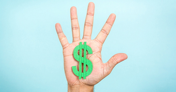 Photo of open hand holding green dollar sign